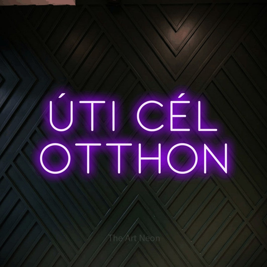 LED neon sign reading “ÚTI CÉL OTTHON”, arranged in two lines.