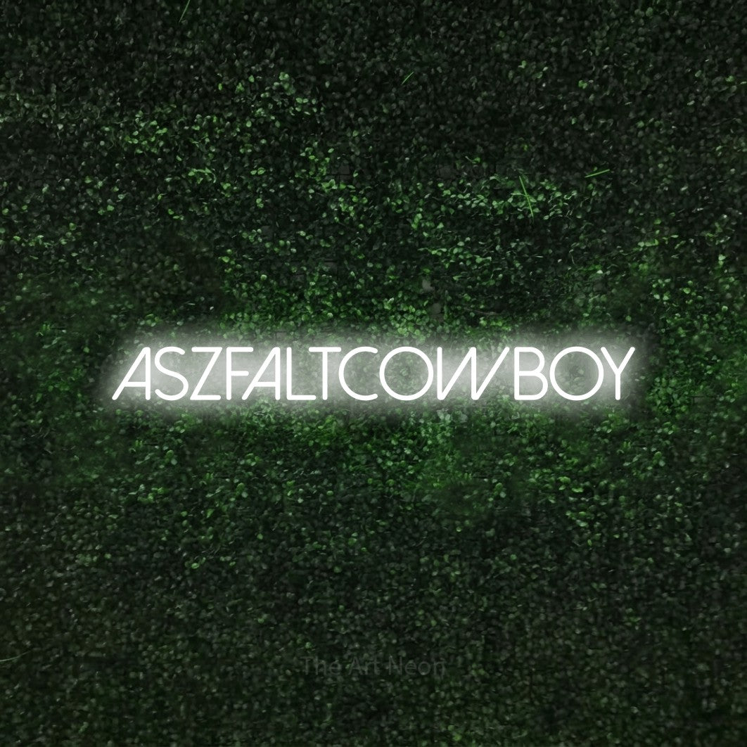 LED neon sign reading “ASZFALTCOWBOY”, arranged in a single line.