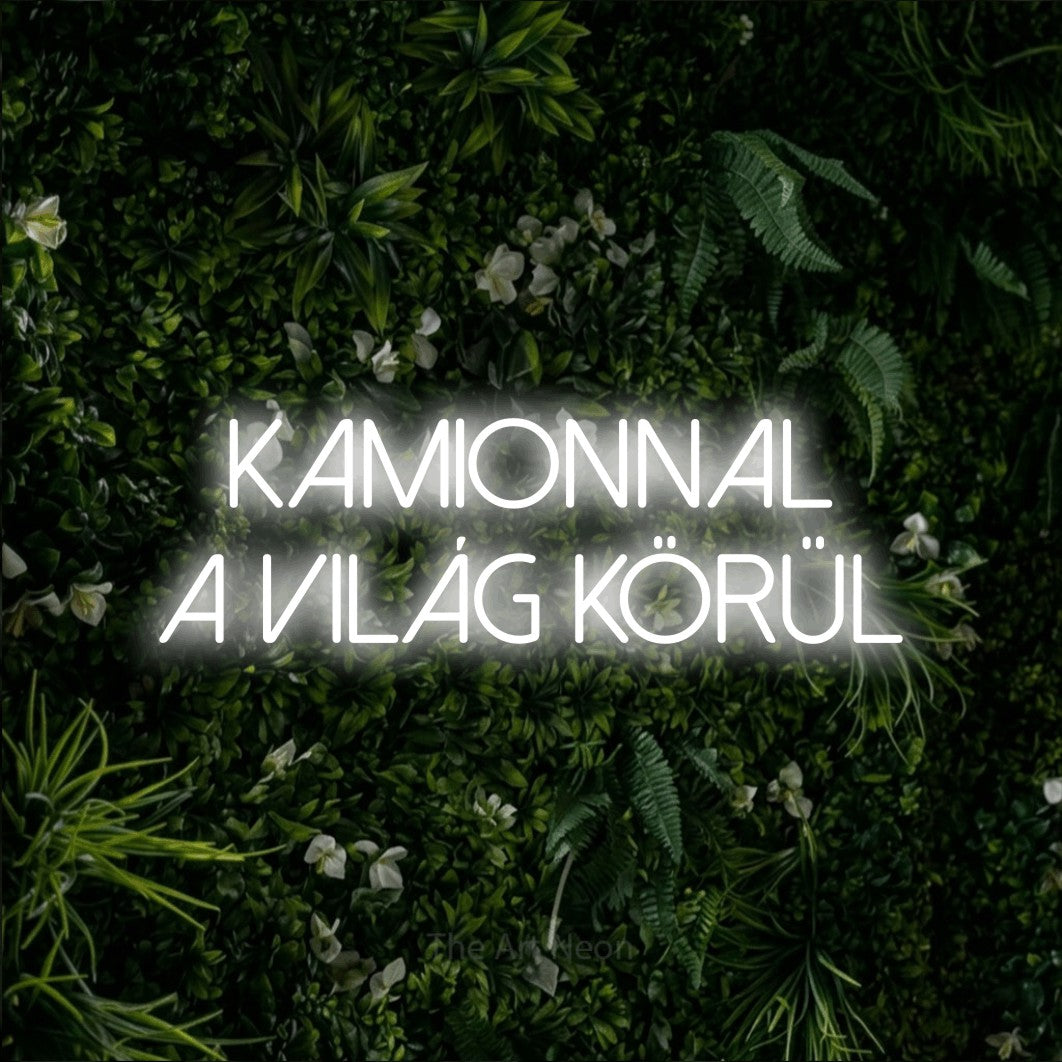 LED neon sign reading “KAMIONNAL A VILÁG KÖRÜL”, arranged in two lines.