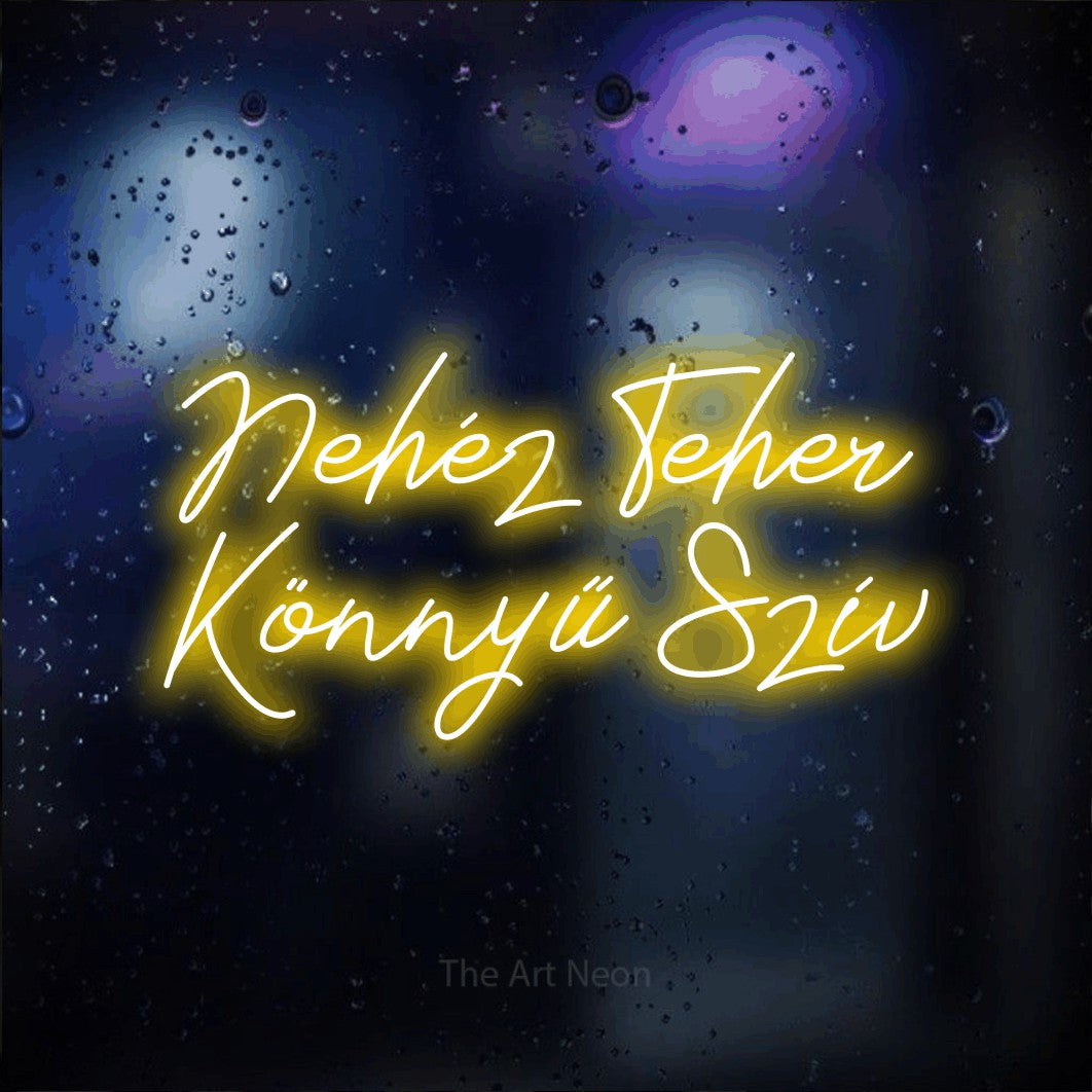 LED neon sign reading “Nehéz Teher Könnyű Szív”, arranged in two lines.