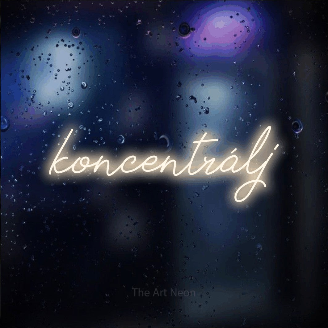 LED neon sign reading “koncentrálj”, arranged in a single line.