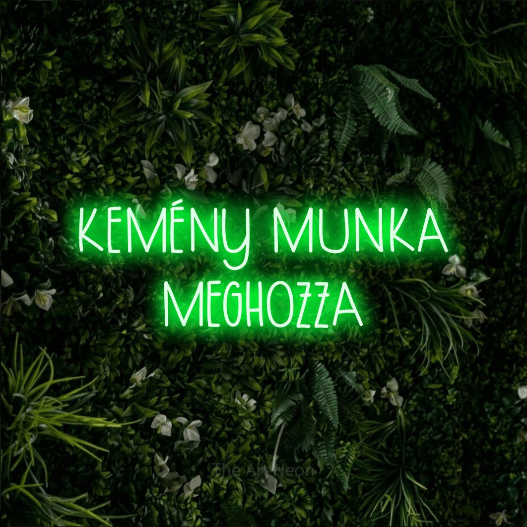 LED neon sign reading “KEMÉNY MUNKA MEGHOZZA”, arranged in two lines.