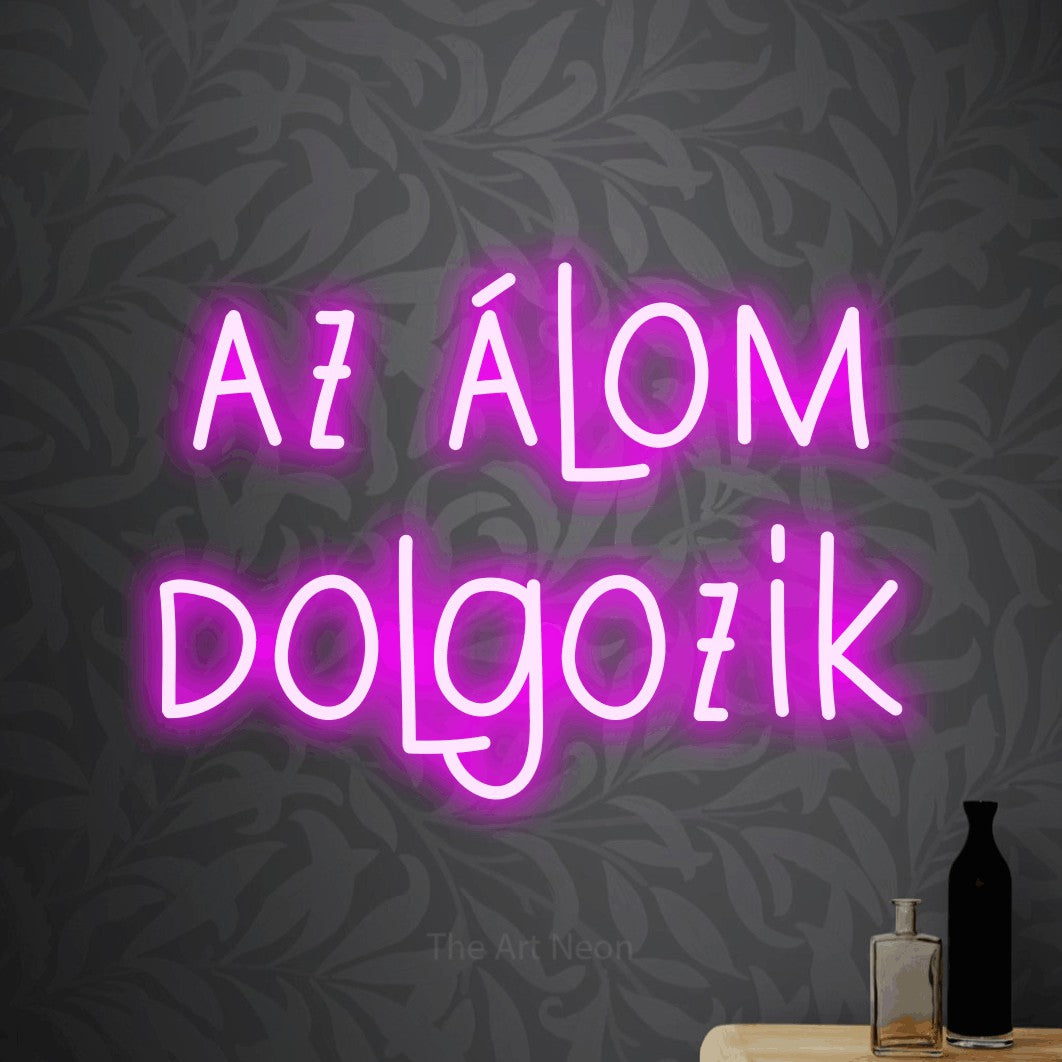 LED neon sign reading “az álom dolgozik”, arranged in two lines.