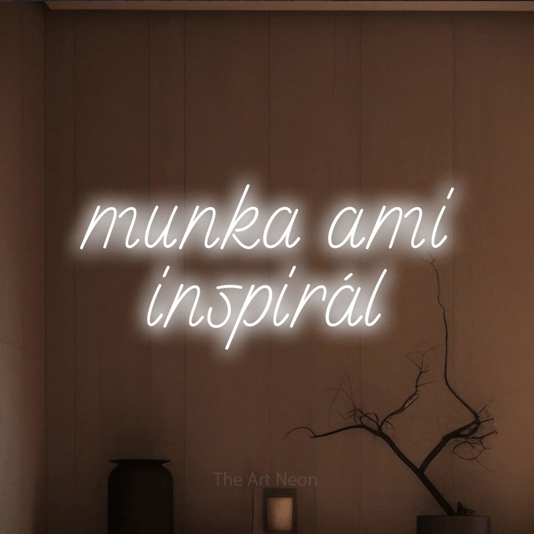 LED neon sign reading “munka ami inspirál”, arranged in two lines.