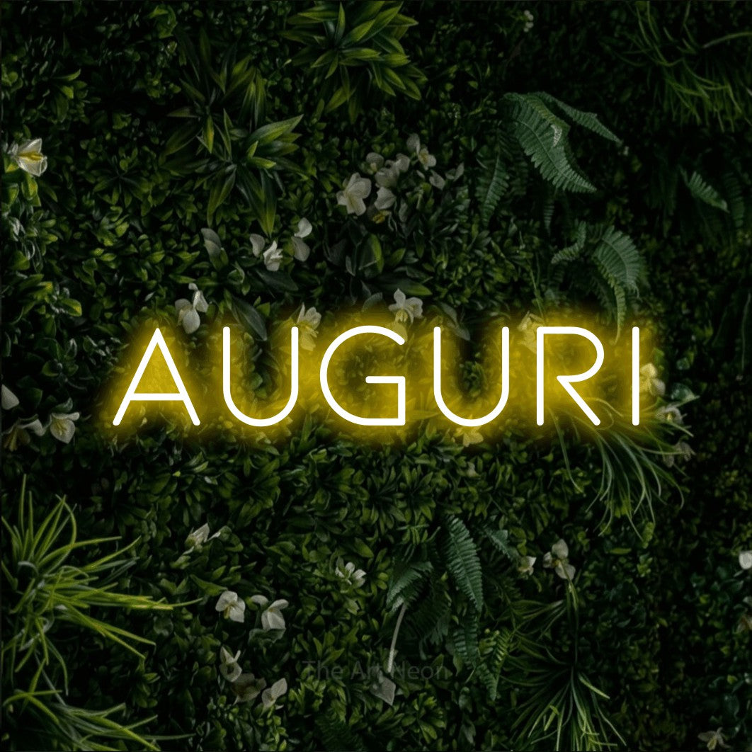 LED neon sign reading “AUGURI”, arranged in a single line.