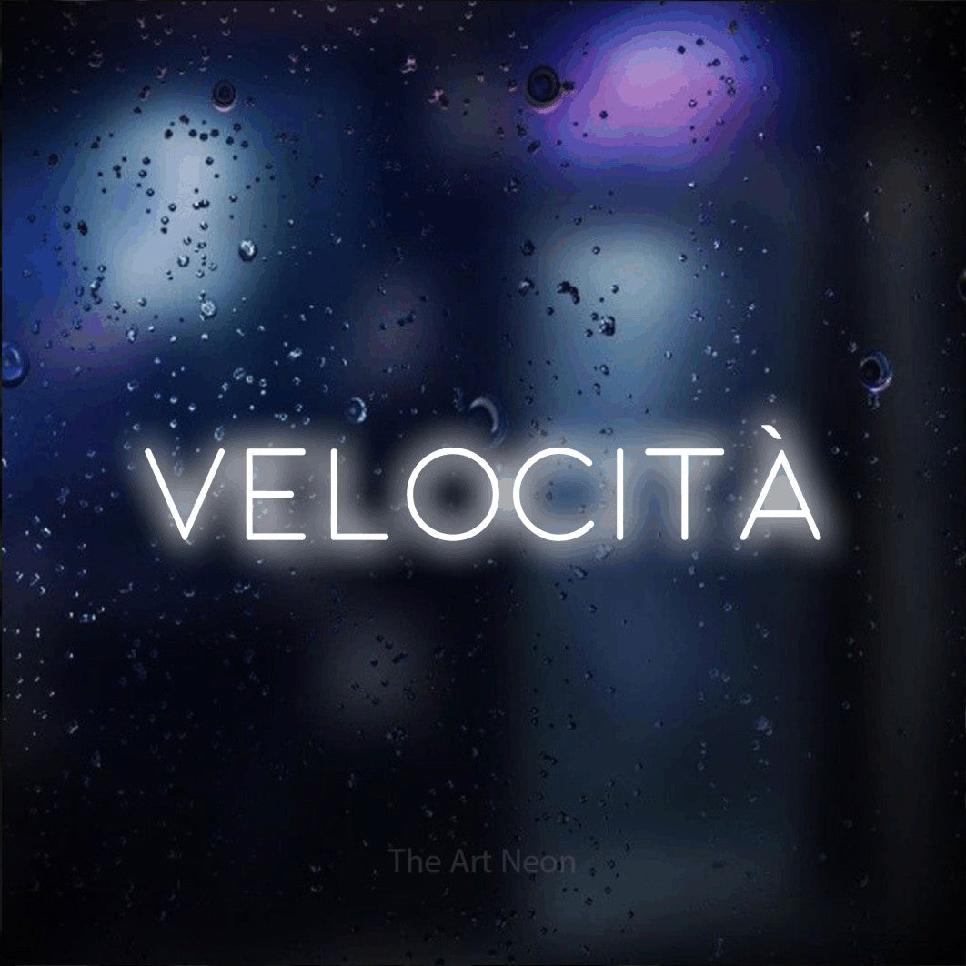 LED neon sign reading “velocità”, arranged in a single line.