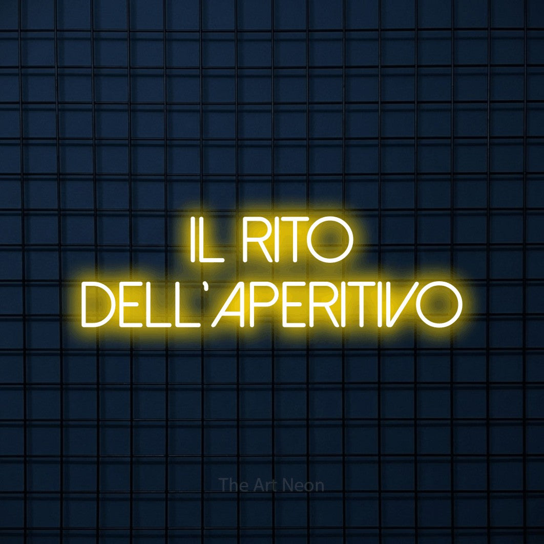 LED neon sign reading “il rito dell'aperitivo”, arranged in 2 lines.