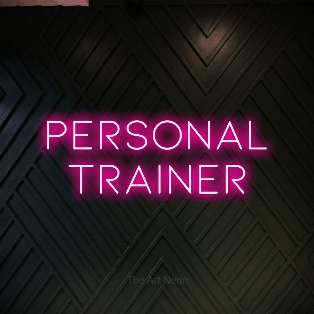 LED neon sign reading “personal trainer”, arranged in 2 lines.