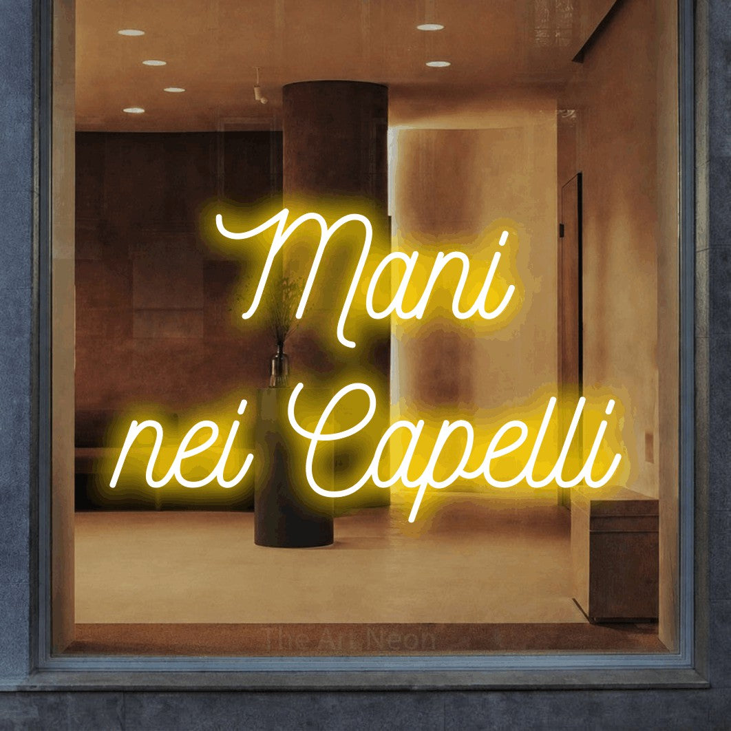 LED neon sign reading “Mani nei Capelli”, arranged in 2 lines.