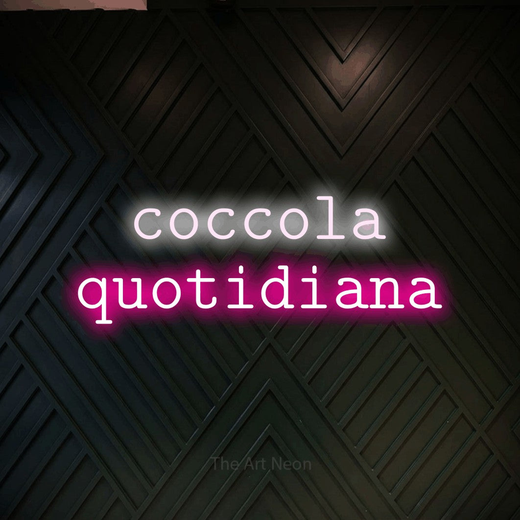 LED neon sign reading “coccola quotidiana”, arranged in 2 lines.