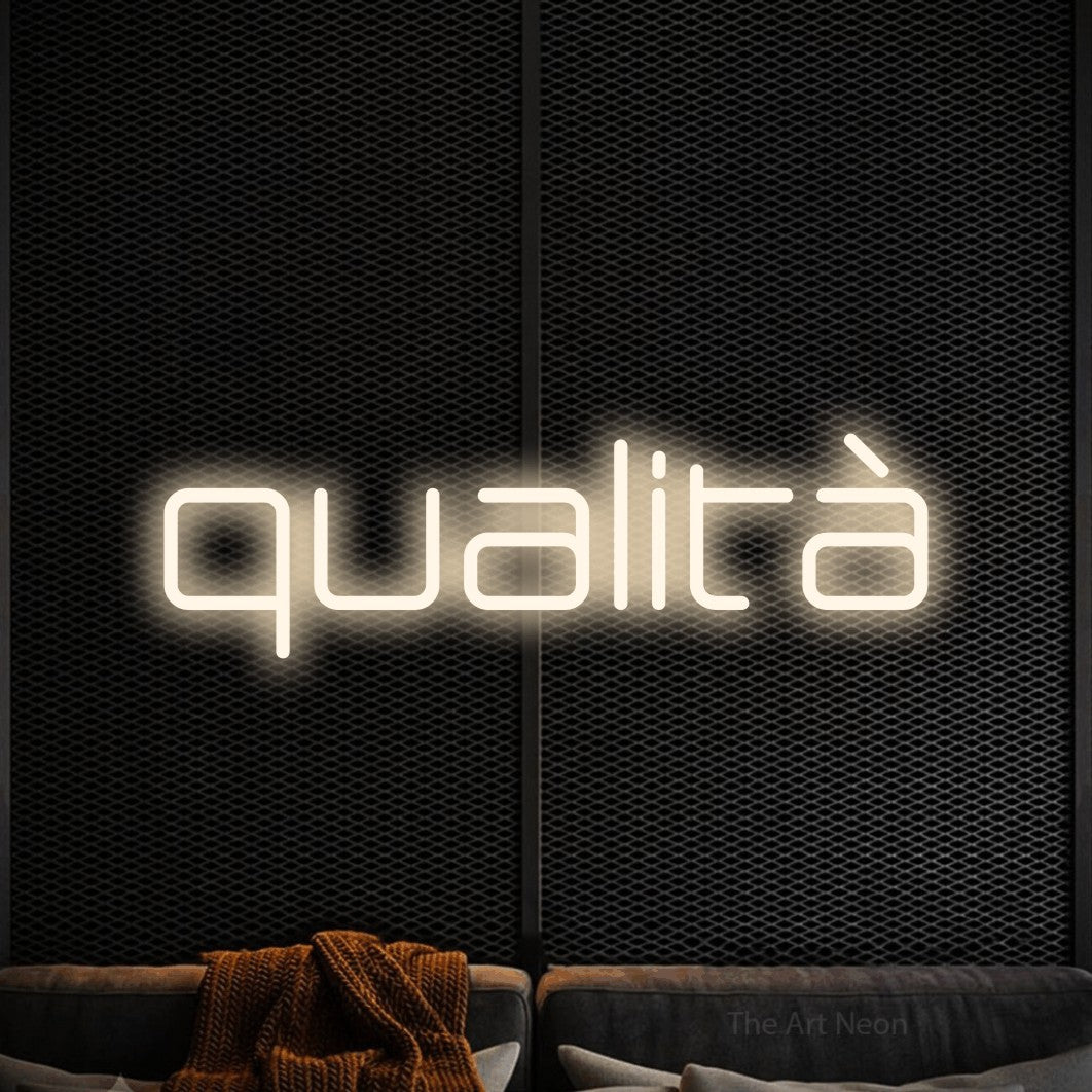LED neon sign reading “qualità”, arranged in a single line.