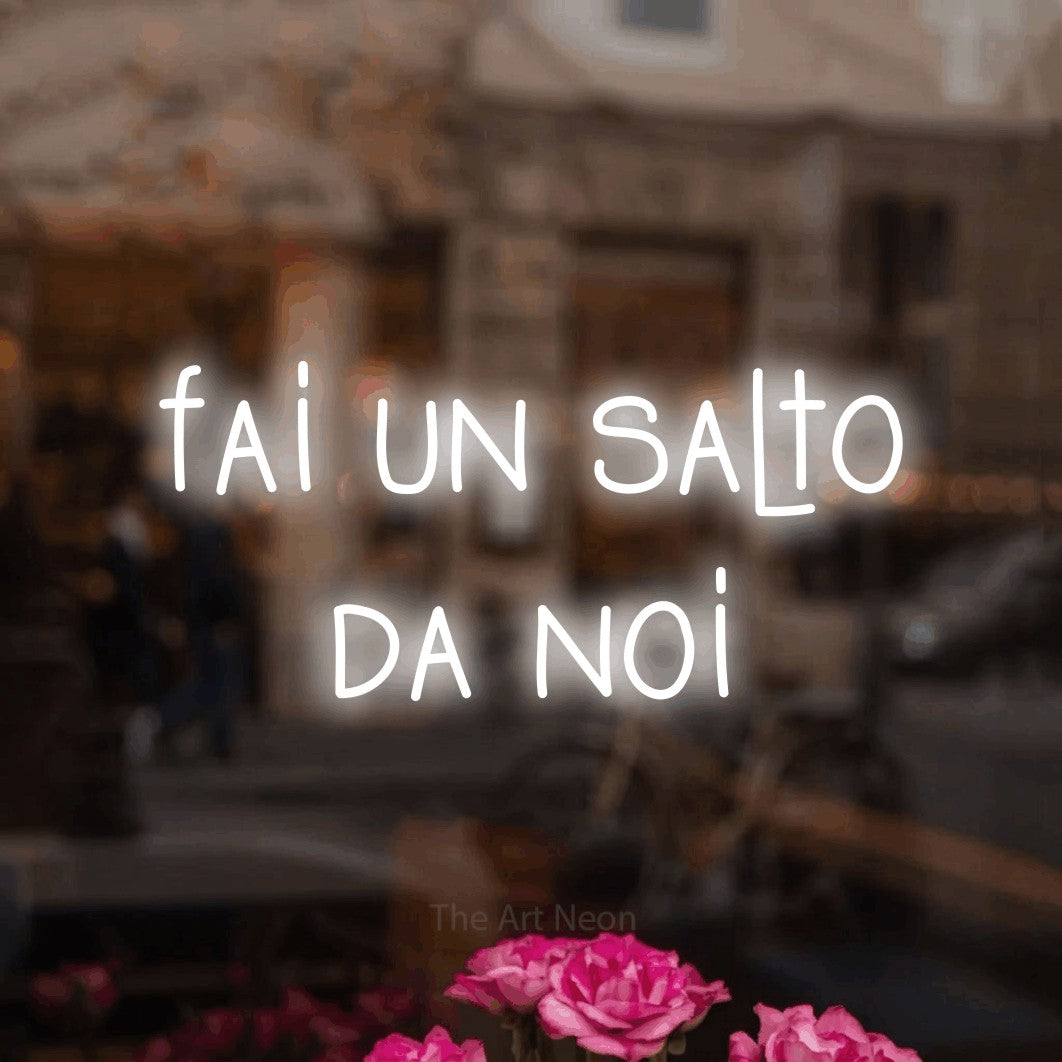 LED neon sign reading “fai un salto da noi”, arranged in 2 lines.