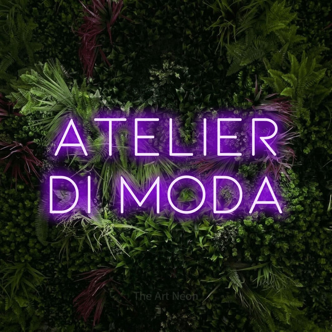 LED neon sign reading “atelier di moda”, arranged in 2 lines.