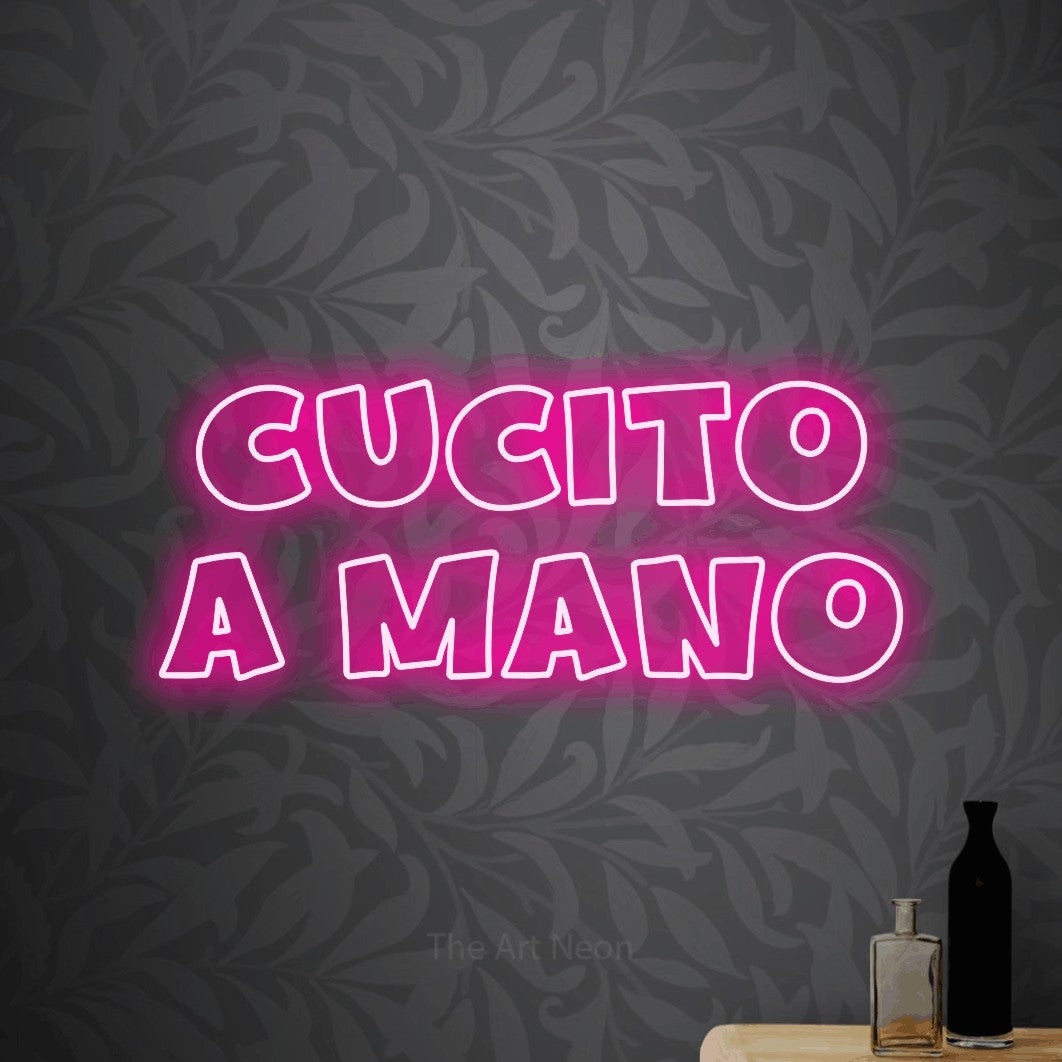LED neon sign reading “CUCITO A MANO”, arranged in 2 lines.