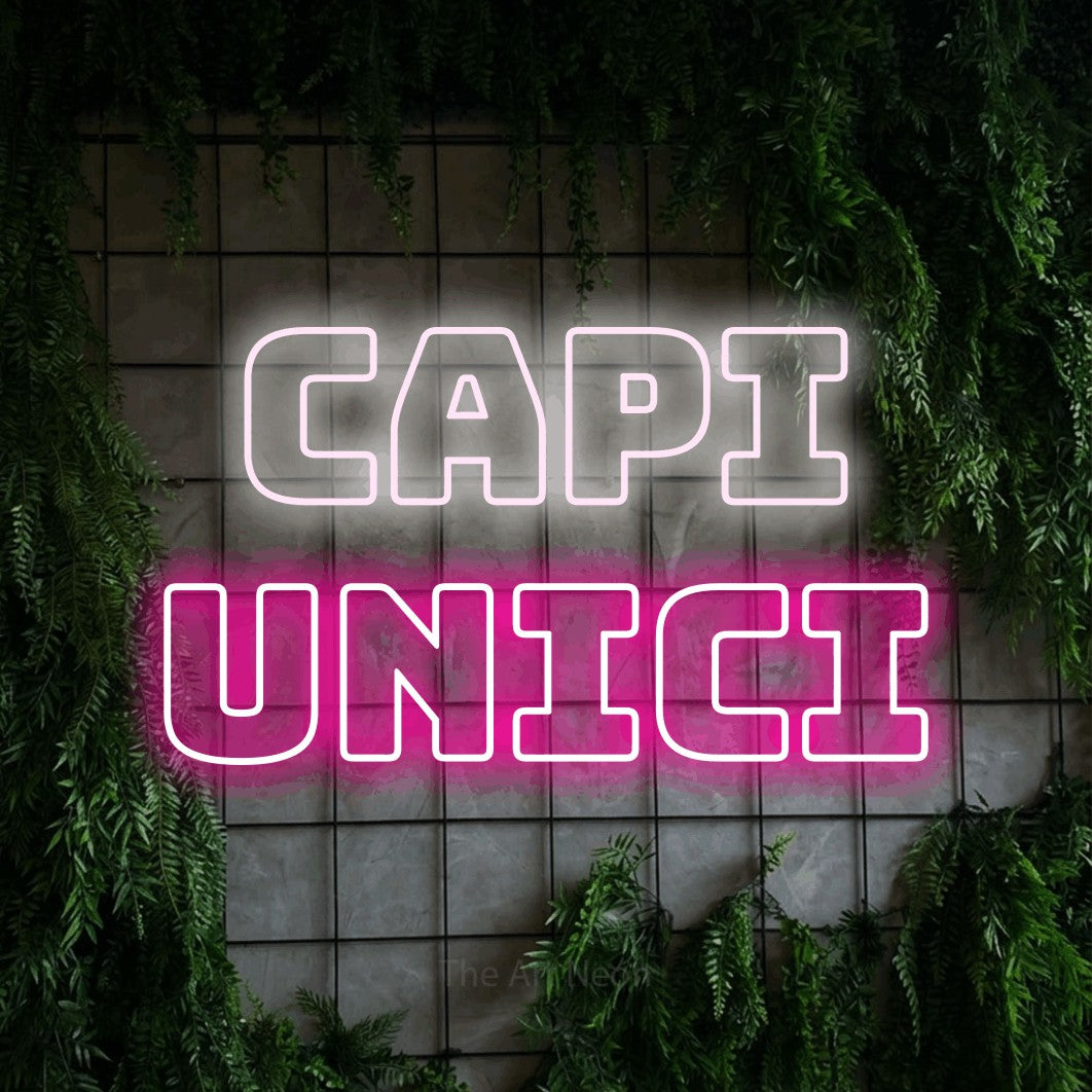 LED neon sign reading “CAPI UNICI”, arranged in 2 lines.