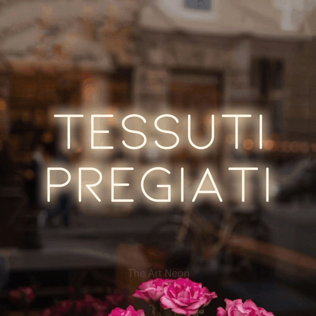 LED neon sign reading “Tessuti Pregiati”, arranged in 2 lines.
