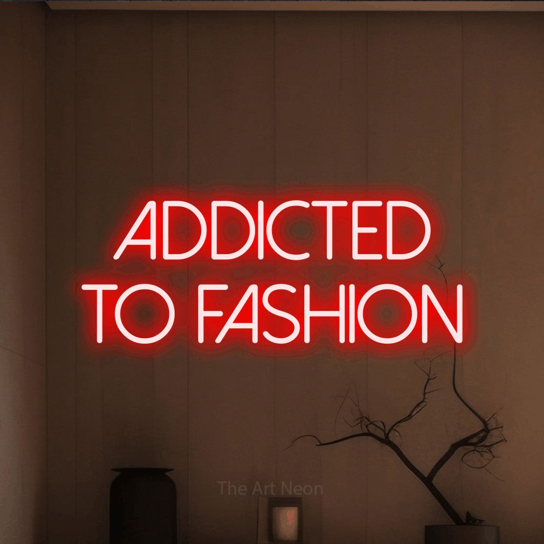 LED neon sign reading “Addicted to Fashion”, arranged in 2 lines.