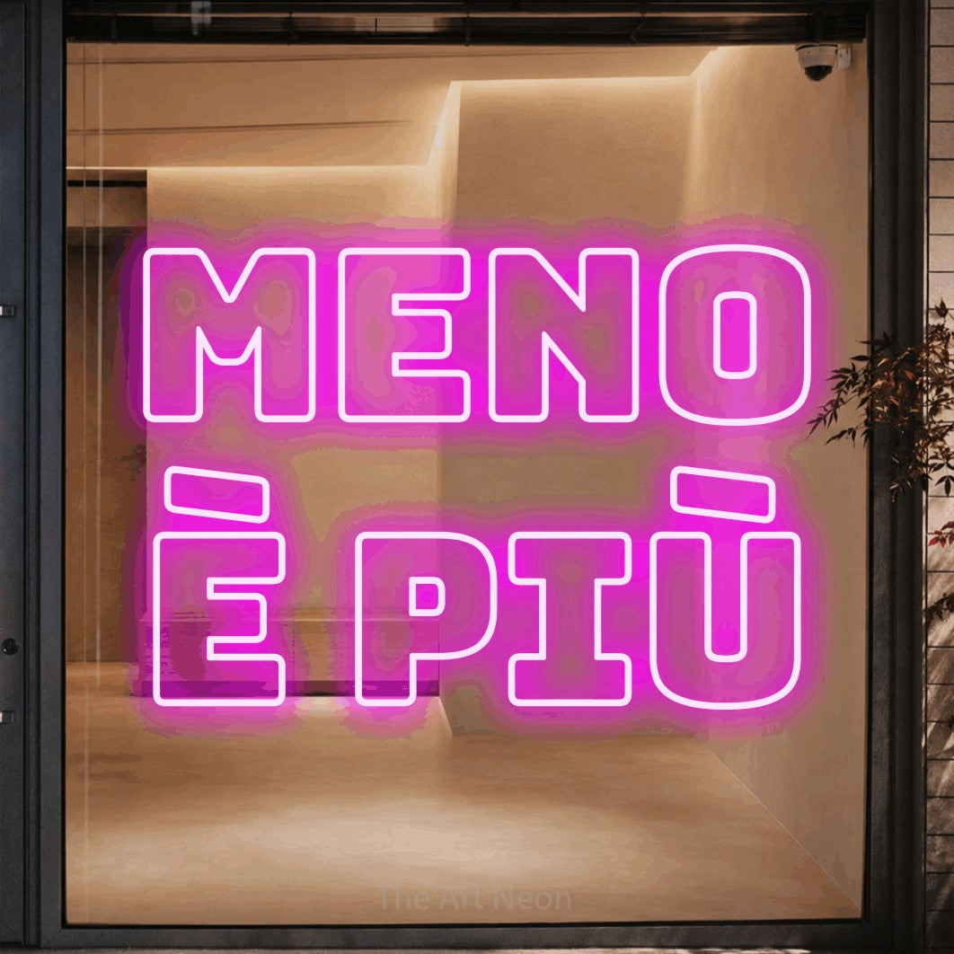 LED neon sign reading “meno è più”, arranged in 2 lines.