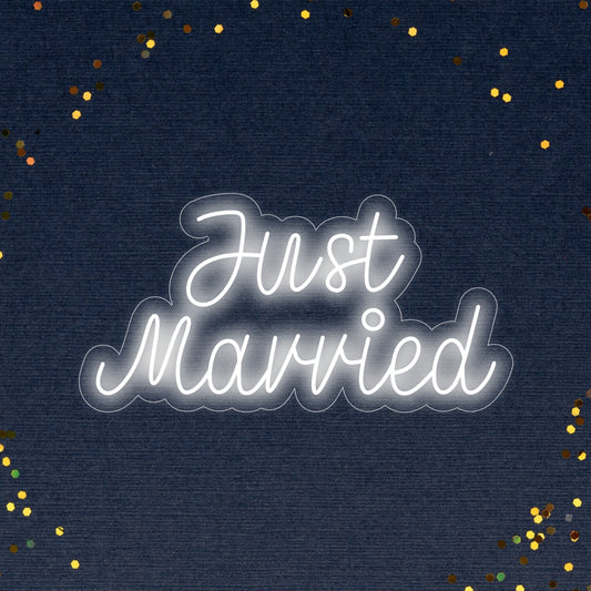 "Just Married Neon Sign" - Light up your special day with this charming neon sign featuring the words "Just Married," spreading love and joy.