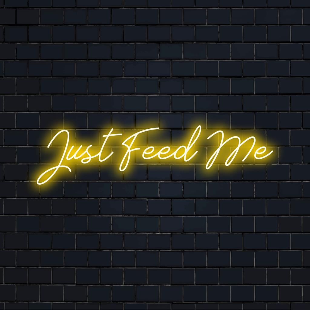 Vibrant LED neon art piece reading 'Just Feed Me,' perfect for illuminating any space with bold, custom neon style.