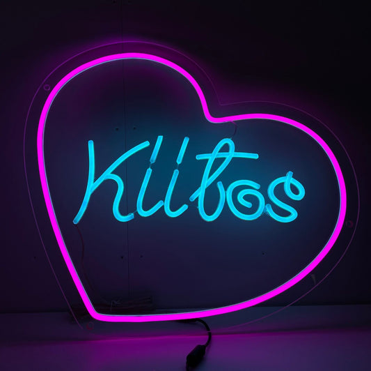 "Kiitos Heart Neon Sign" – Elevate your space with this neon sign that combines the Finnish word "Kiitos" with a heart, radiating gratitude and warmth. Perfect for cozy spots and places that celebrate appreciation.