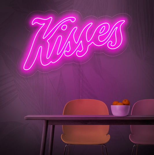 An illuminated neon sign featuring the word 'Kisses', symbolizing love and romance, adding a touch of passion and charm to any space