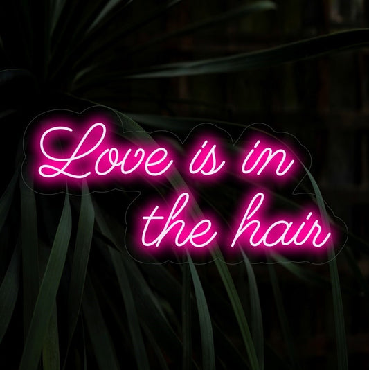 "Love Is In The Hair Neon Sign" is a romantic and stylish addition for spaces celebrating the beauty of hair. Illuminate with love and flair!