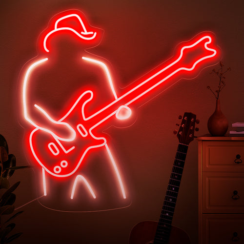 L'enseigne néon « Un homme joue de la guitare » capture l'essence de la passion musicale avec une silhouette jouant de la guitare. Sublimez votre espace grâce à la lueur rythmique de ce néon élégant et captivant.