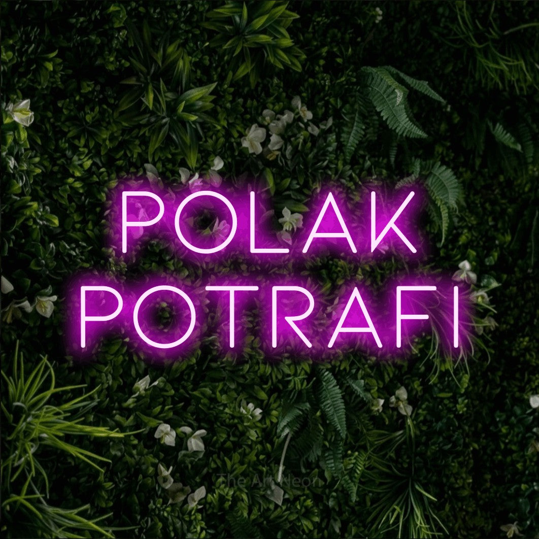 LED neon sign reading “Polak potrafi”, arranged in two lines.