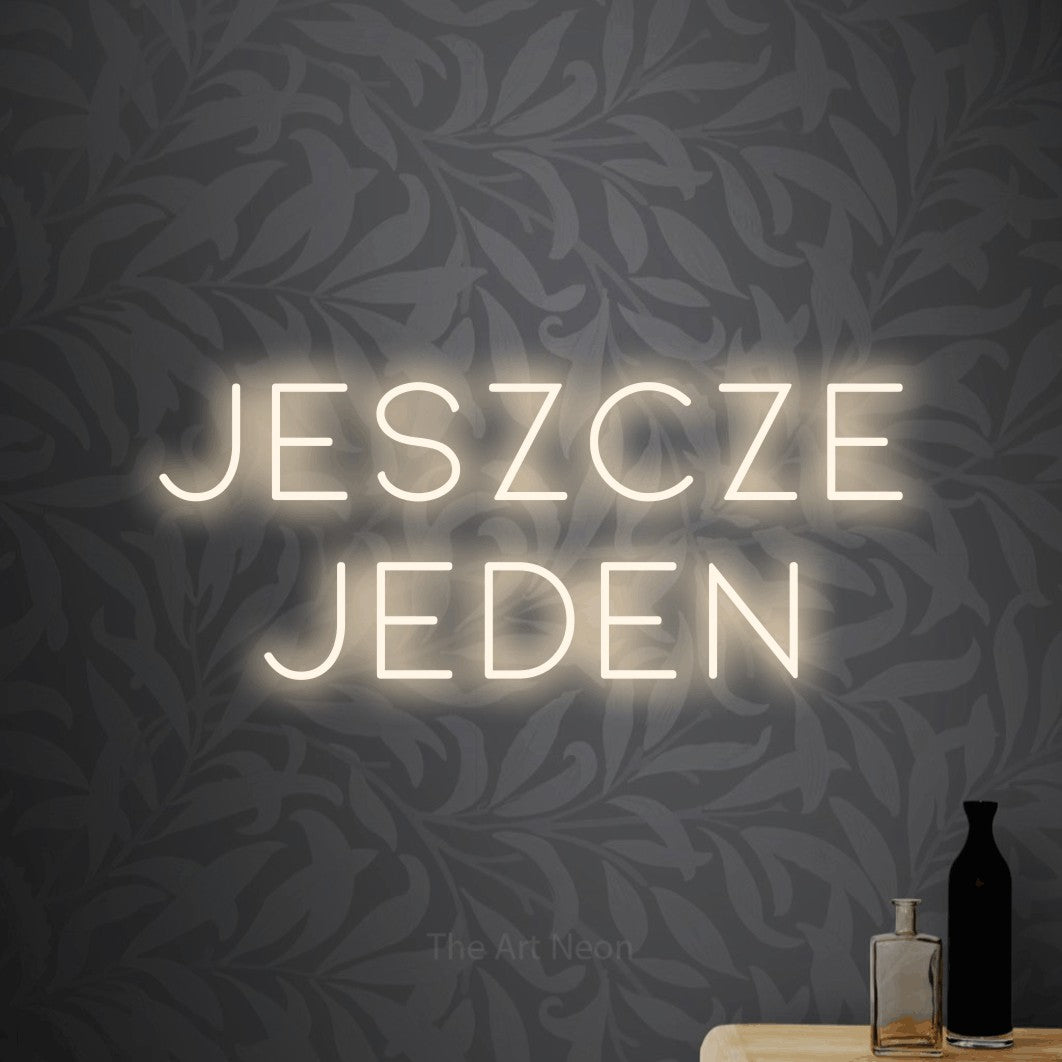 LED neon sign reading “Jeszcze jeden”, arranged in two lines.