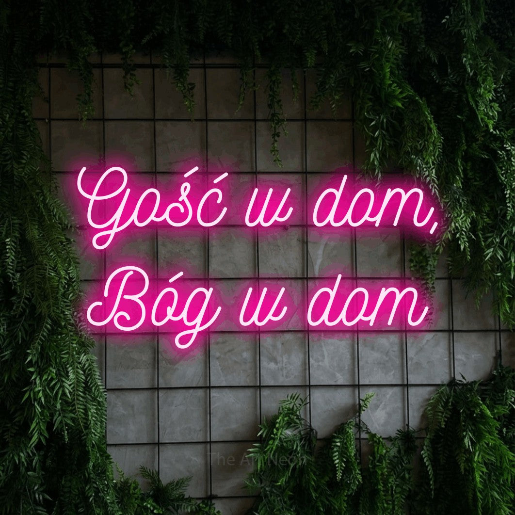 LED neon sign reading “Gość w dom, Bóg w dom”, arranged in two lines.
