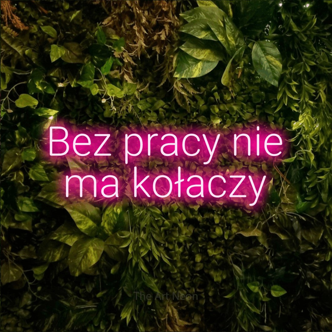 LED neon sign reading “Bez pracy nie ma kołaczy”, arranged in two lines.