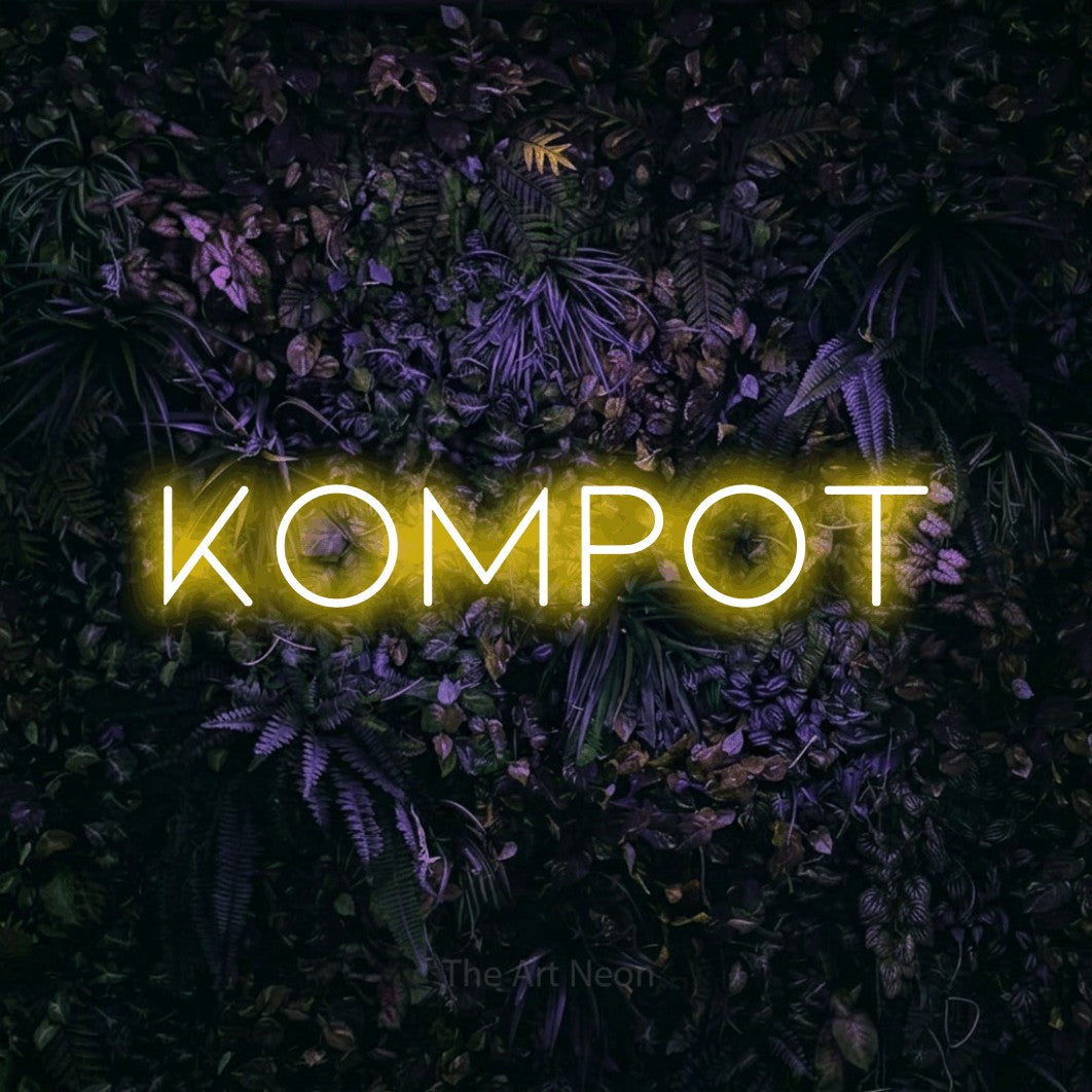 LED neon sign reading “Kompot”, arranged in a single line.