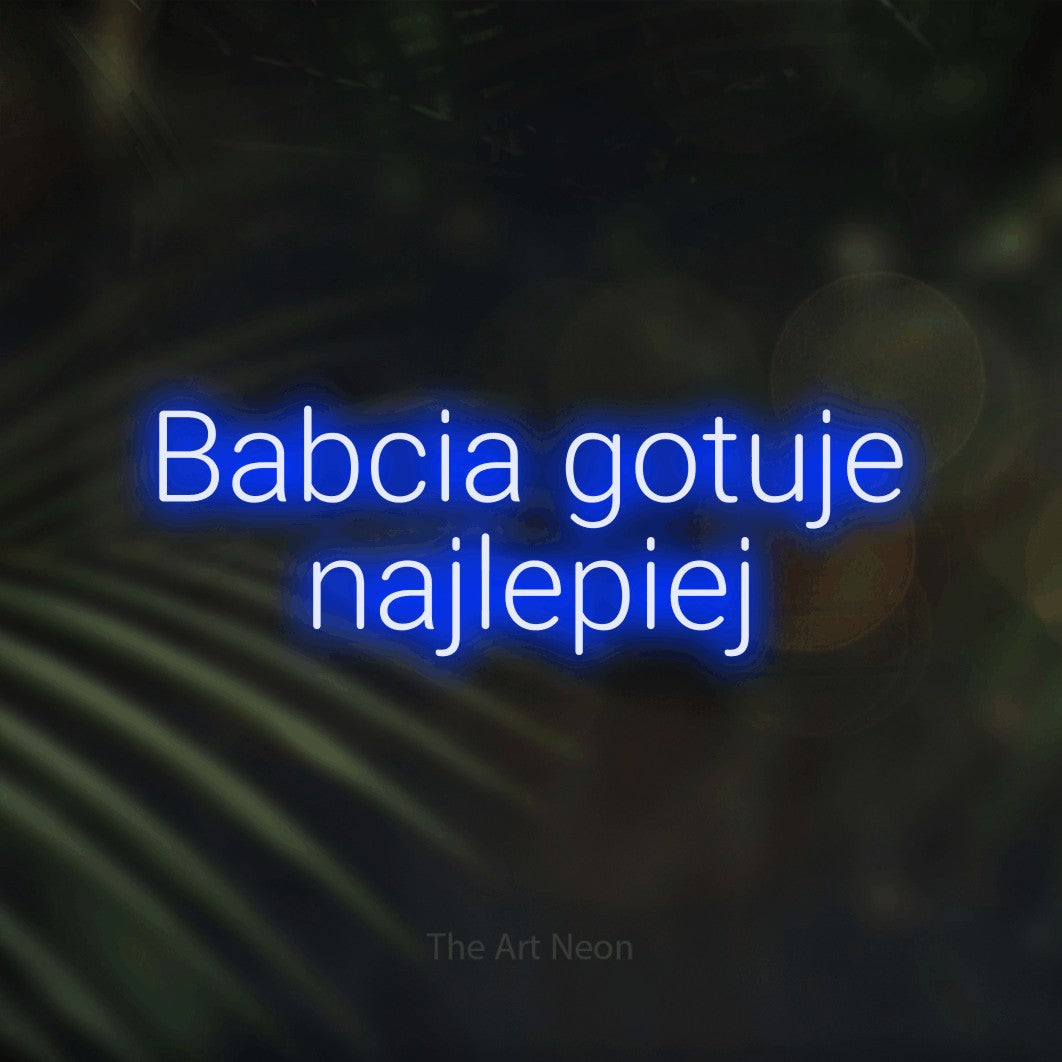 LED neon sign reading “Babcia gotuje najlepiej”, arranged in two lines.
