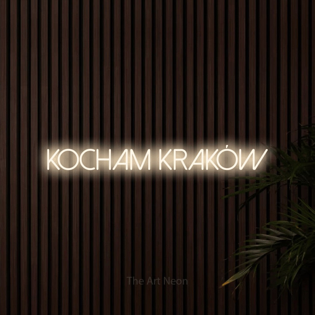 LED neon sign reading “Kocham Kraków”, arranged in a single line.