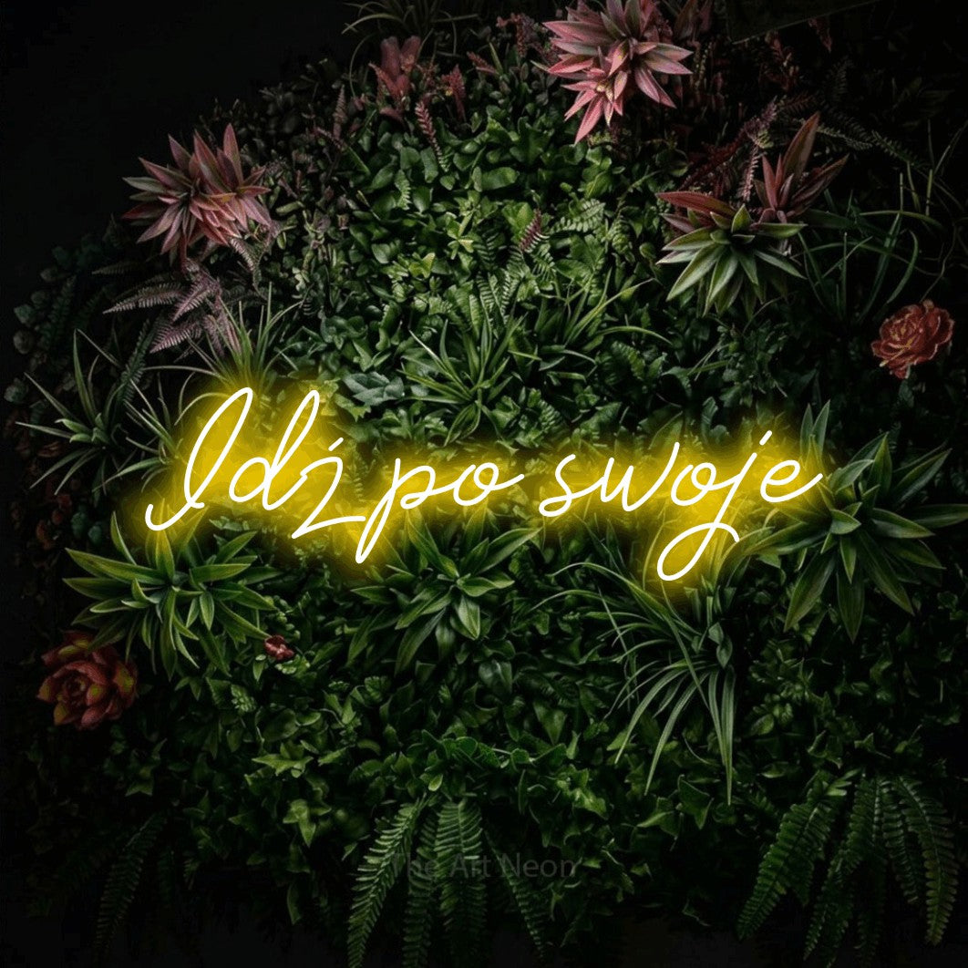 LED neon sign reading “Idź po swoje”, arranged in a single line.