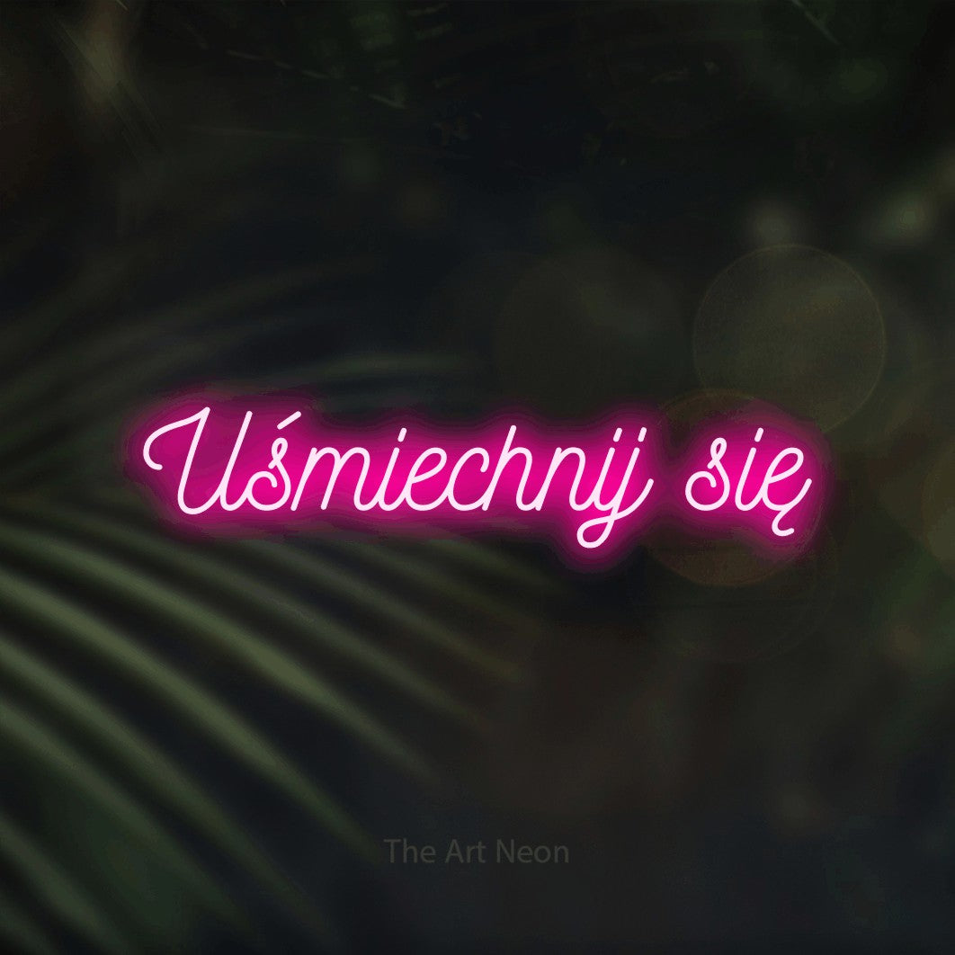 LED neon sign reading “Uśmiechnij się”, arranged in a single line.