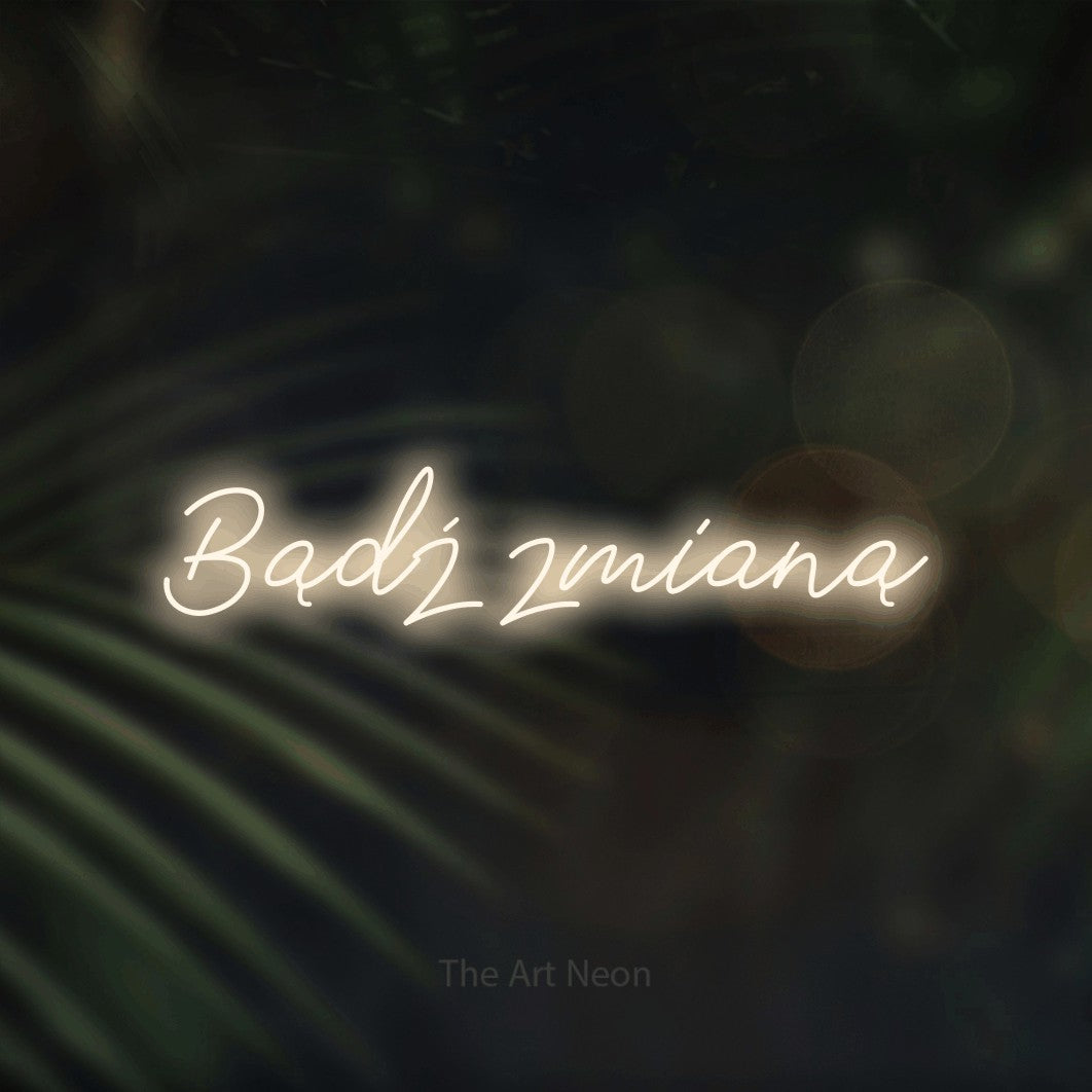 LED neon sign reading “Bądź zmianą”, arranged in a single line.