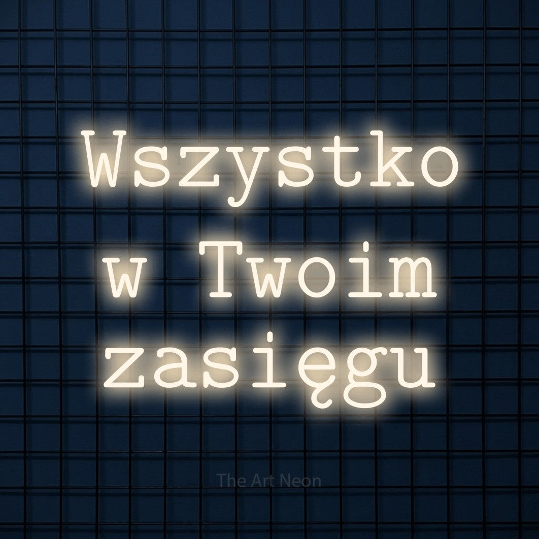 LED neon sign reading “Wszystko w Twoim zasięgu”, arranged in three lines.