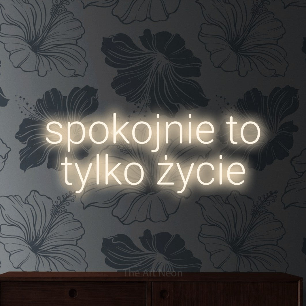 LED neon sign reading “spokojnie to tylko życie”, arranged in two lines.