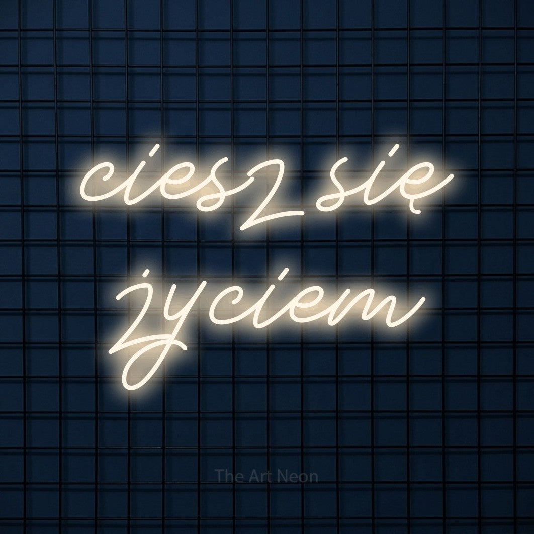 LED neon sign reading “ciesz się życiem”, arranged in two lines.