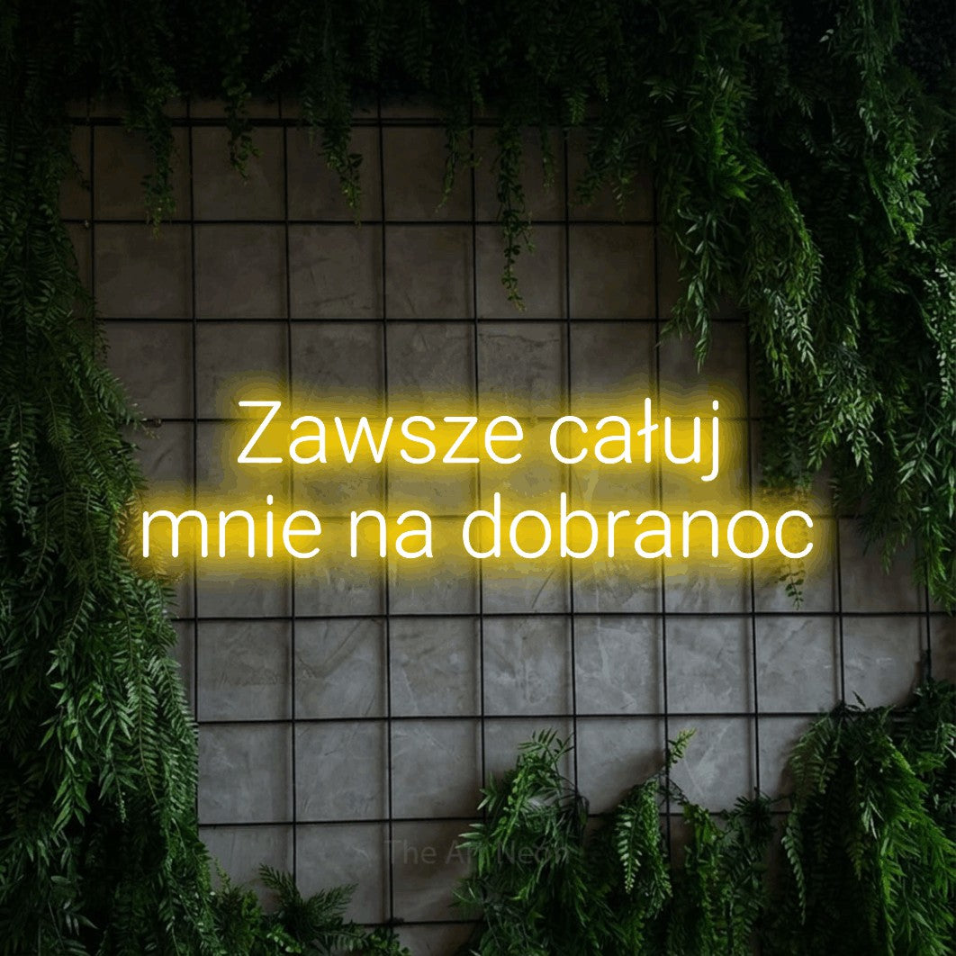 LED neon sign reading “Zawsze całuj mnie na dobranoc”, arranged in two lines.