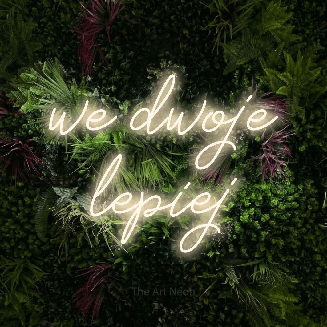 LED neon sign reading “we dwoje lepiej”, arranged in two lines.