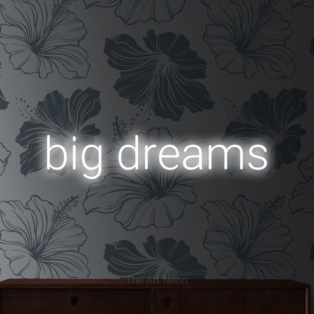 LED neon sign reading “big dreams”, arranged in a single line.