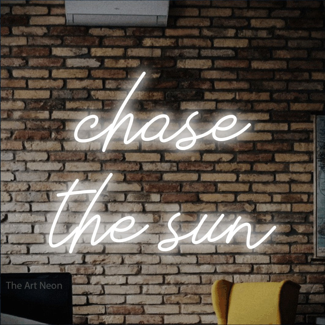 LED neon sign reading “chase the sun”, arranged in two lines.