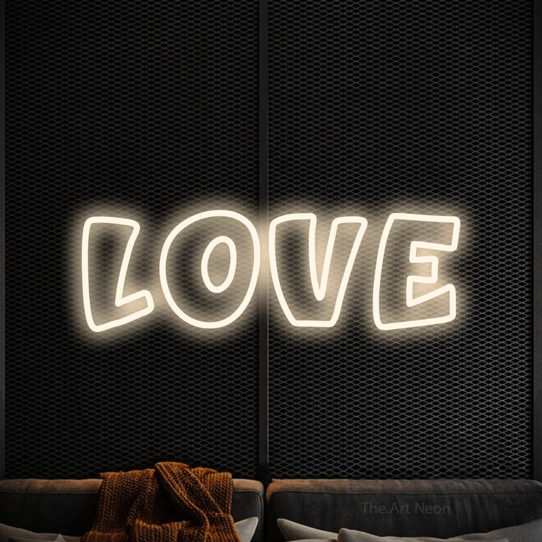 LED neon sign reading “love”, arranged in a single line.