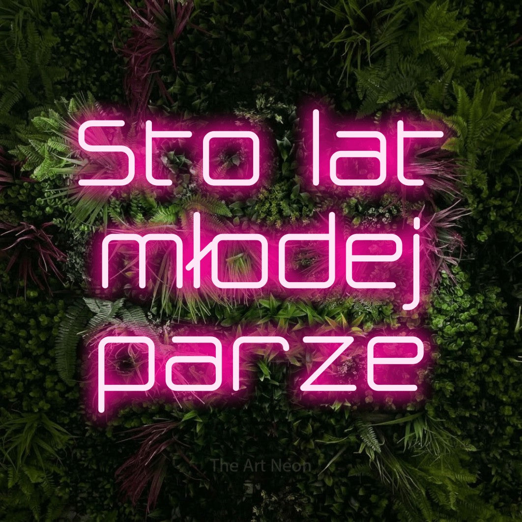 LED neon sign reading “Sto lat młodej parze”, arranged in three lines.