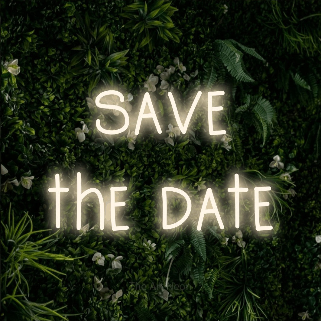 LED neon sign reading “save the date”, arranged in two lines.