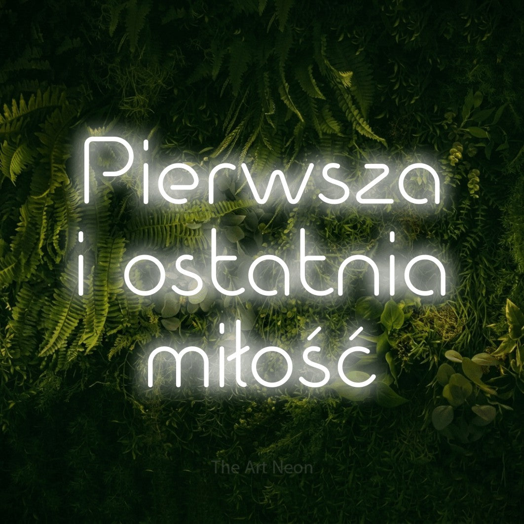 LED neon sign reading “Pierwsza i ostatnia miłość”, arranged in three lines.
