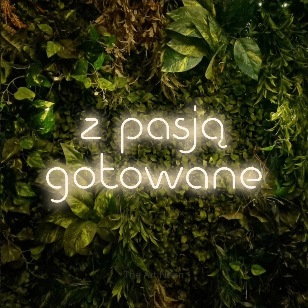 LED neon sign reading “z pasją gotowane”, arranged in two lines.